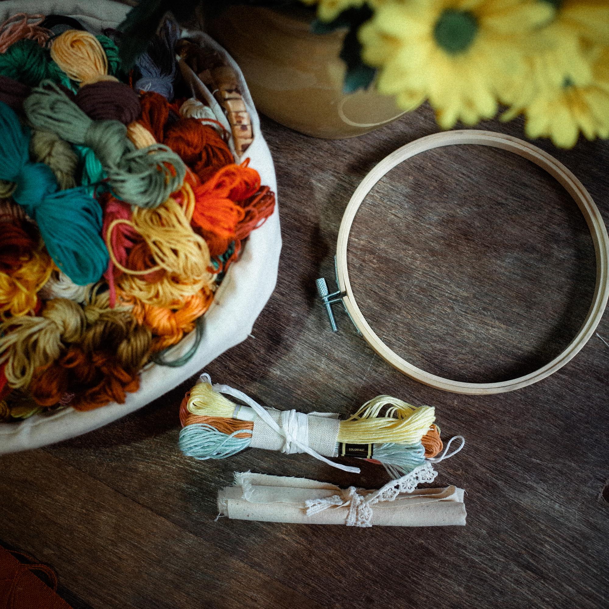 artisanal embroidery workspace with threads and hoops